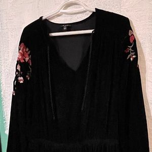 Black velvet dress with embroidery on hem and sleeves.